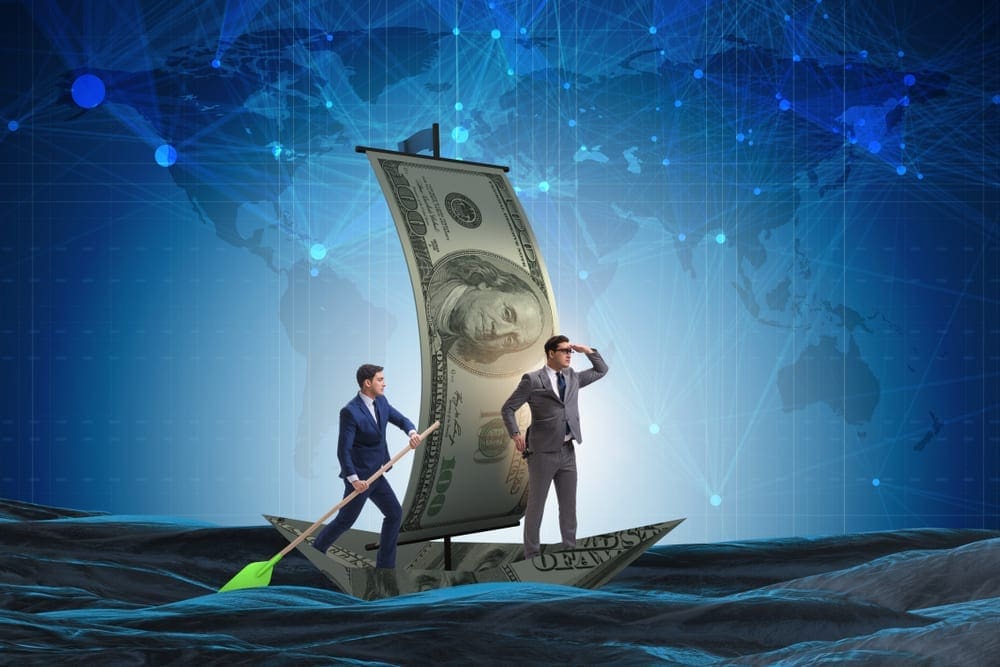Business partnership with businessmen sailing on dollar boat. Elnur / Shutterstock.com