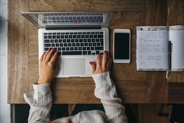 Attractive woman working on a laptop as a virtual assistant