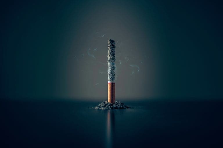 single cigarette stick with ashes stick