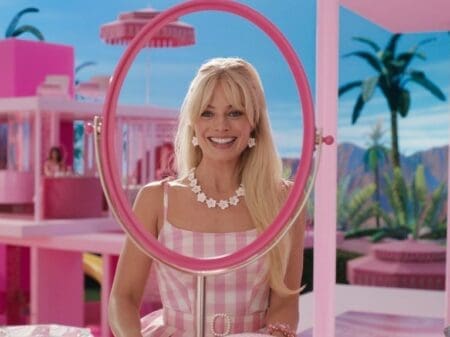 The Barbie movie highlights gender stereotypes and the absurd expectations of being a woman in a 'Kendom' of men