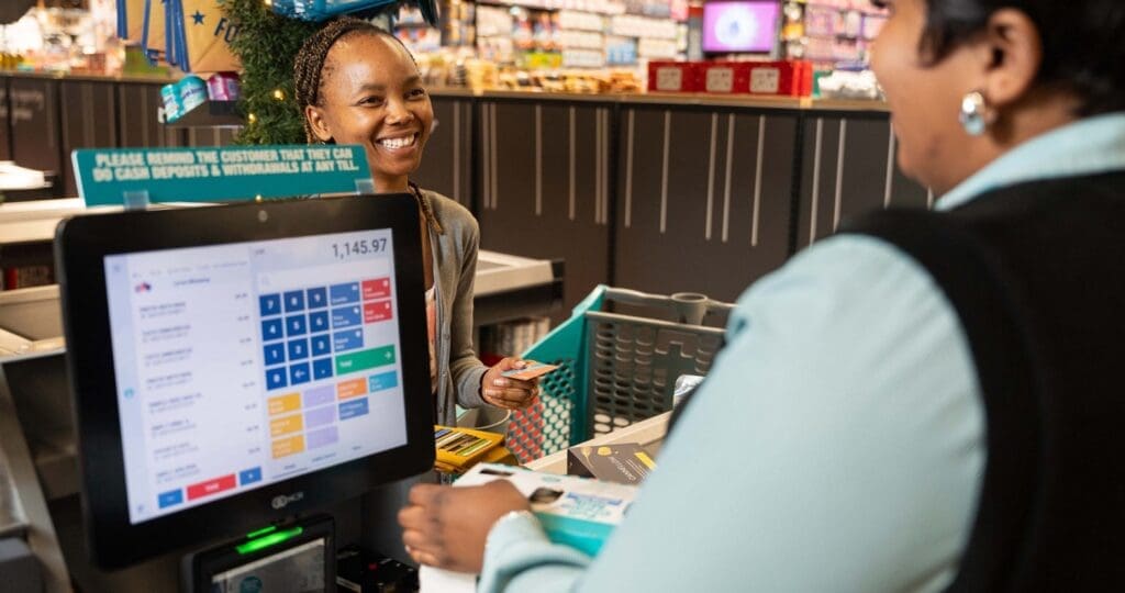 A customer is served at a newly rolled out point-of-sale system in a Checkers Hyper store.