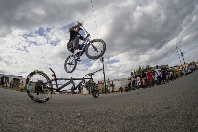 Hloni Ramaila, a BMX rider, jumps over a spinning customised bike in the streets of Soweto during a meetup over the weekend. This cycling subculture was born out of the more commonly known car “stance” culture.