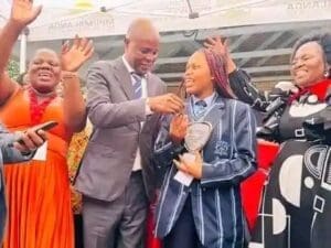 BEST PERFORMER: Luyanda Ndlozi receiving car keys from Mpumalanga Premier Mandla Ndlovu flanked by the joyful Mpumalanga Education MEC Lindi Masina (in black)