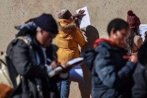 Young South Africans fill in job application forms. More than 60% are jobless.